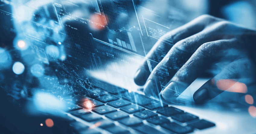 Erläuterndes Bild zu KI im Unternehmen ein menschlicher Anwender dessen Hände sichtbar sind tippen auf einer Tastatur über der schwebend Daten durch Symbole dargestellt werden